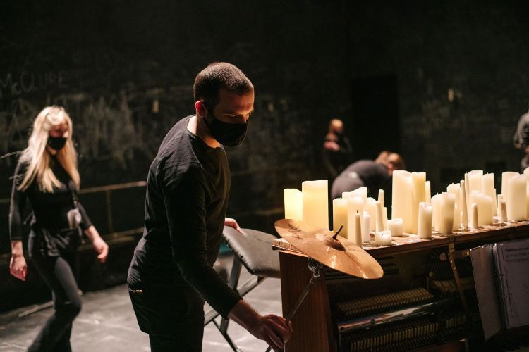 Ophir Westman lighting artificial candles on set